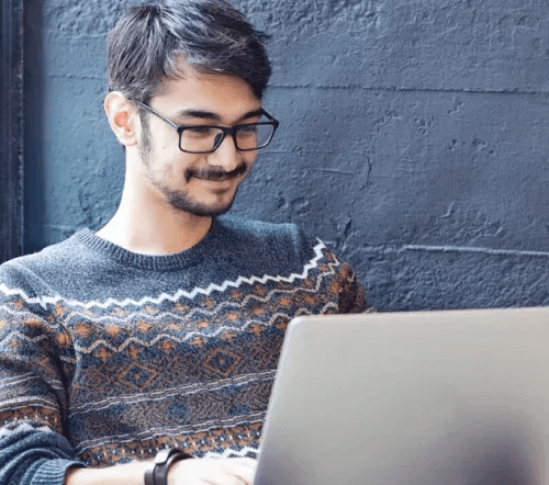 Person working at a computer desk with monitor