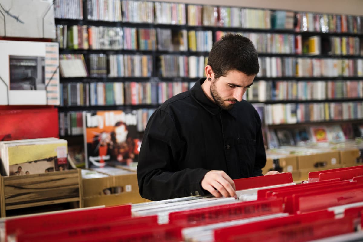 Young man working with books in library